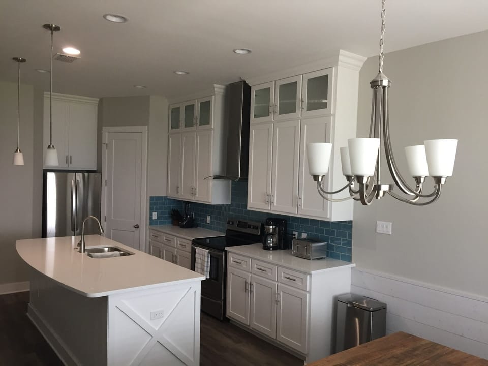 The modern kitchen has everything you may need like coffee maker toaster etc    