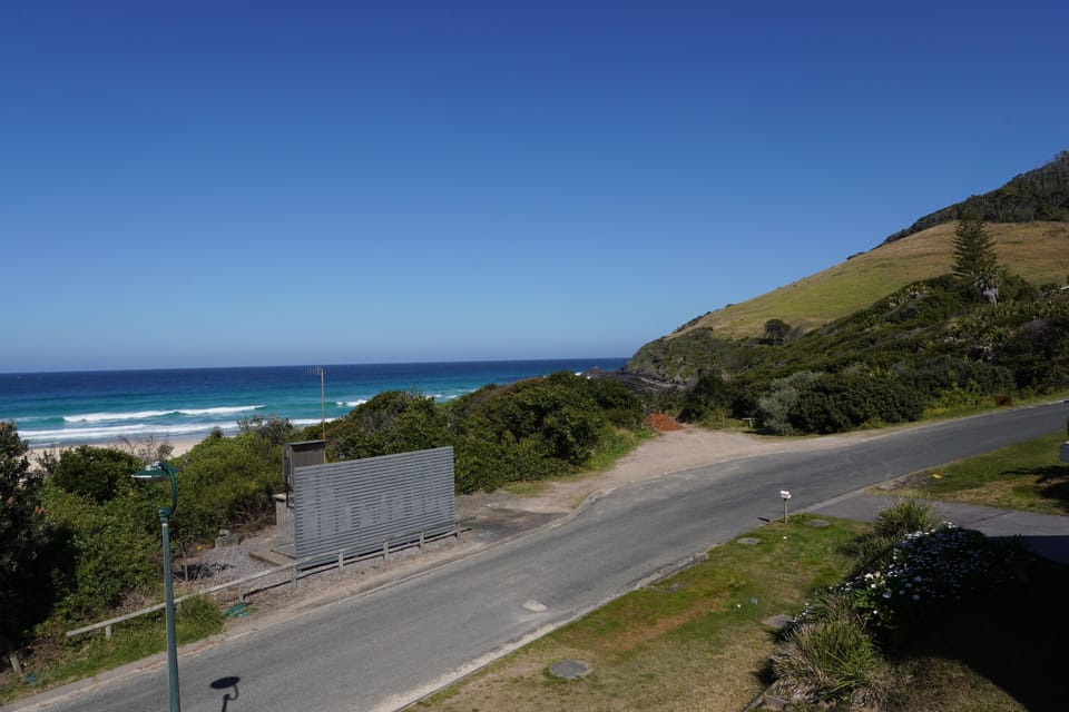 Balcony views of Blueys beach a hill side

