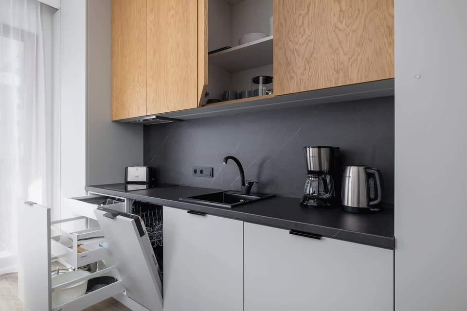 Another perspective of the kitchen, showcasing built-in appliances and under-cabinet lighting.
