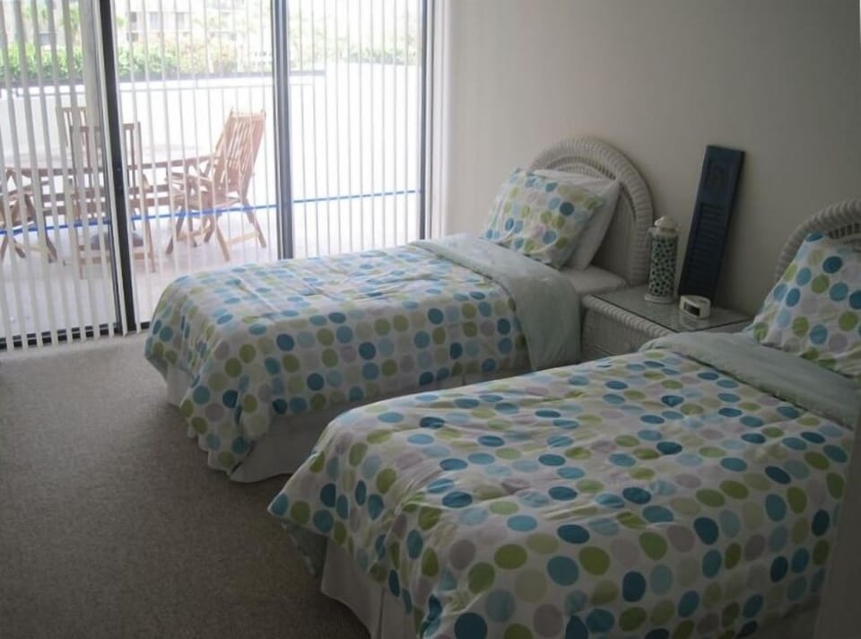 Second bedroom, two single beds, sliding door to large balcony