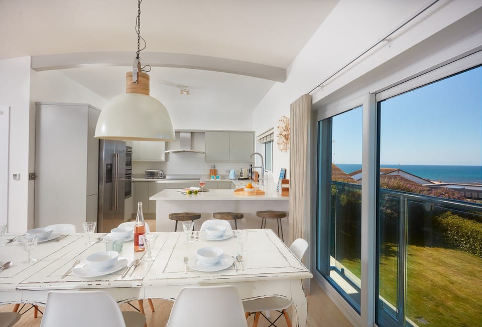 Sundown in Bude, Cornwall. First floor: Dining area with large table and seating for eight. Perfect for an evening meal with family and friends.