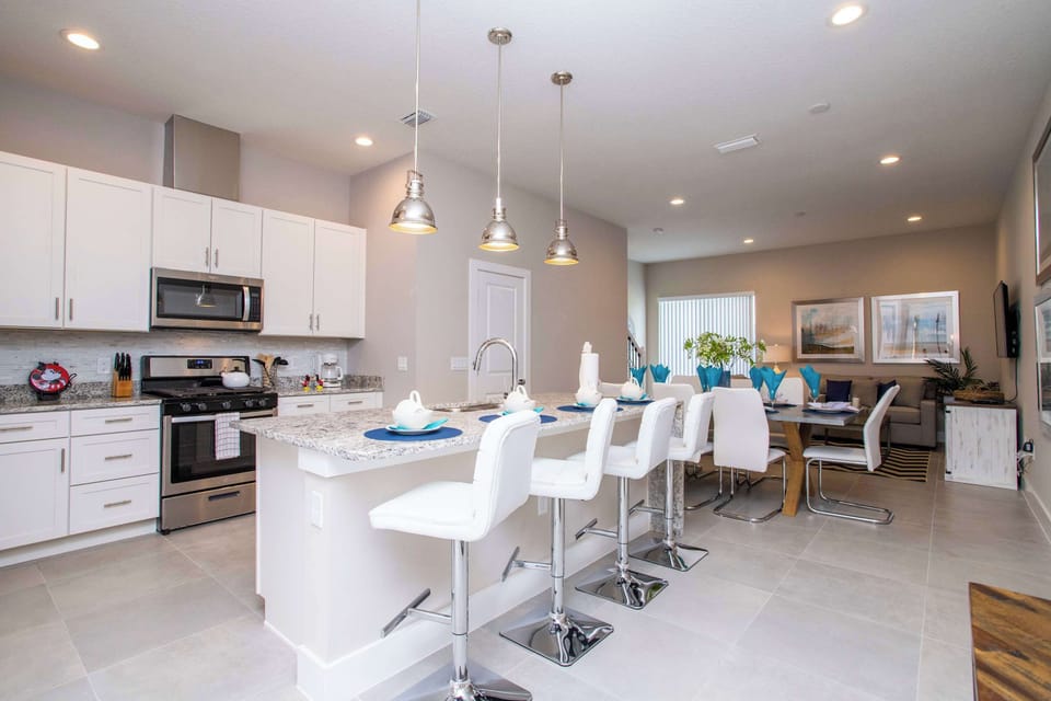 The heart of the home! This spacious kitchen and dining area is perfect for entertaining. With stylish bar seating and a large dining table, there's room for the whole crew to relax and recharge.