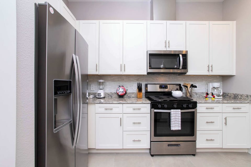 Modern convenience meets Disney charm. This bright kitchen is stocked with everything you need, from a coffee maker to a Mickey waffle iron, making every morning of your vacation feel special.