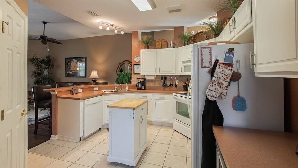 Open-concept kitchen with ample counter space, modern appliances, and a cozy island.