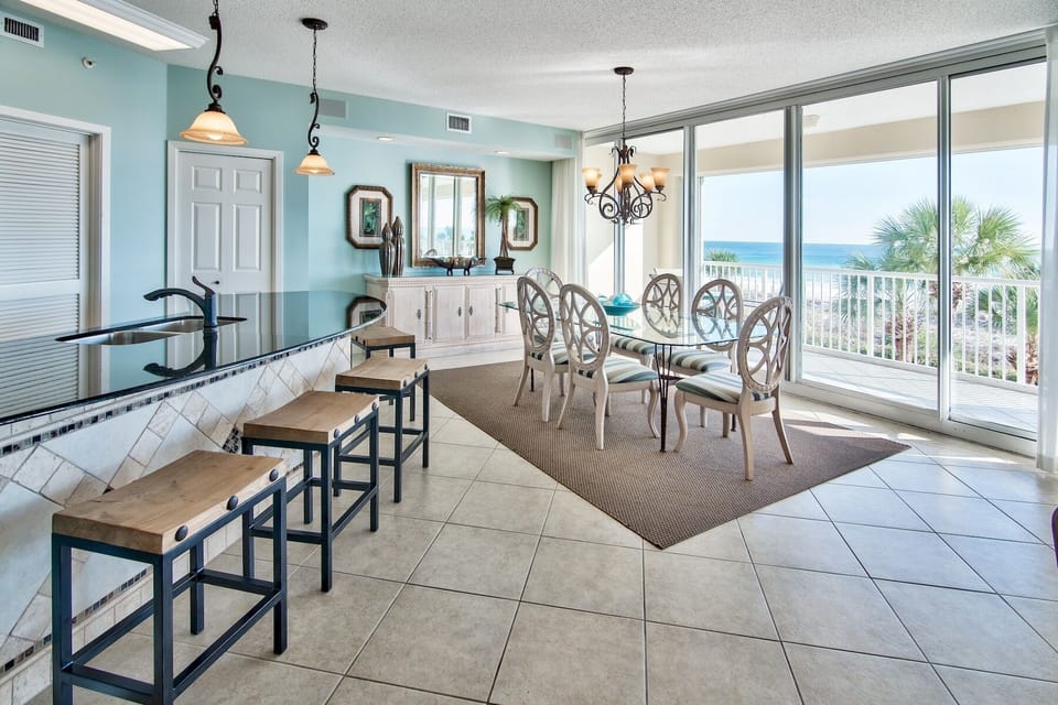 Dining room table has seating for 6 plus 4 chairs at the counter.