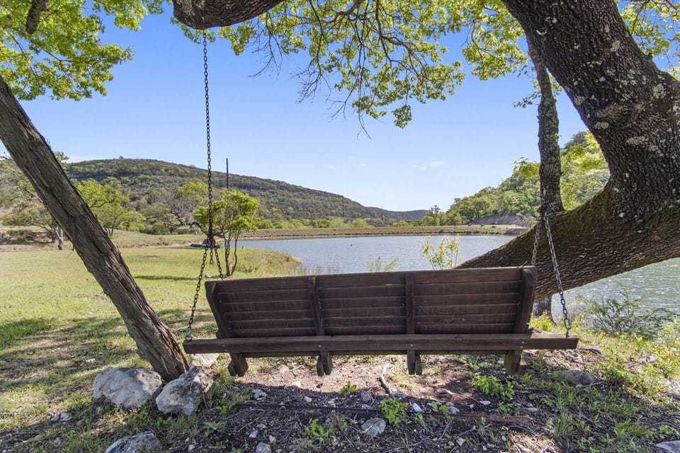Unwind on the lakeside swing under shady trees and take in the serene beauty of nature.