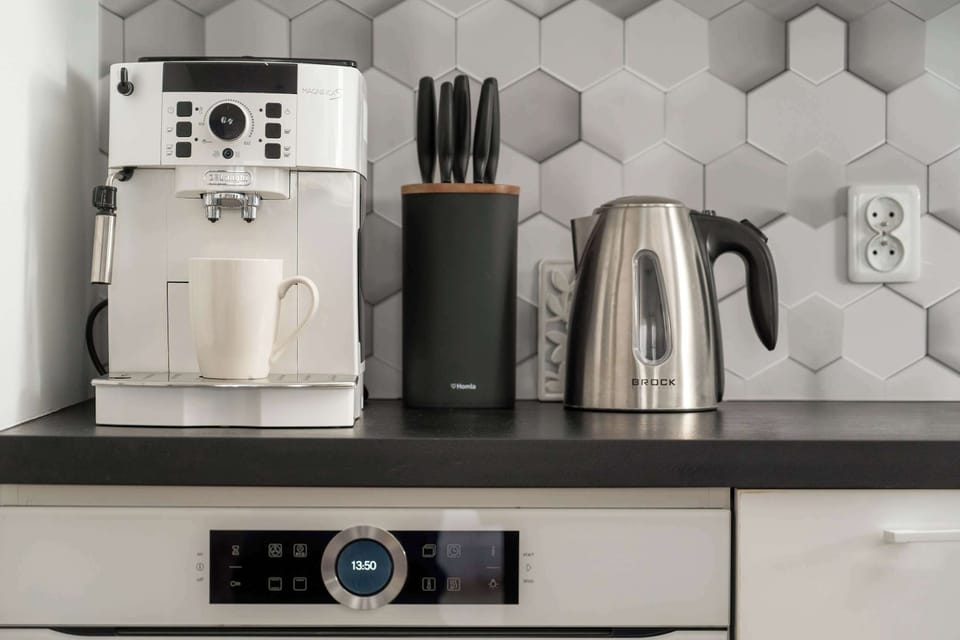 A detailed view of kitchen appliances, including a coffee machine, toaster, and kettle, highlighting convenience for guests.