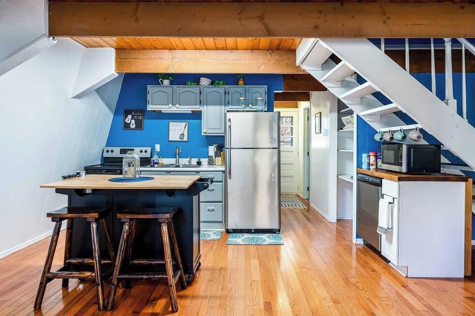 A different angle of the kitchen featuring entry way into downstairs bedroom.