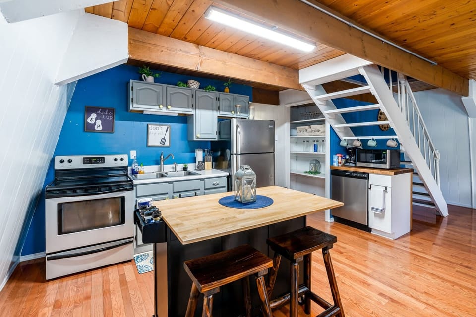 Fully-stocked kitchen with a dishwasher, stove/oven, and microwave.