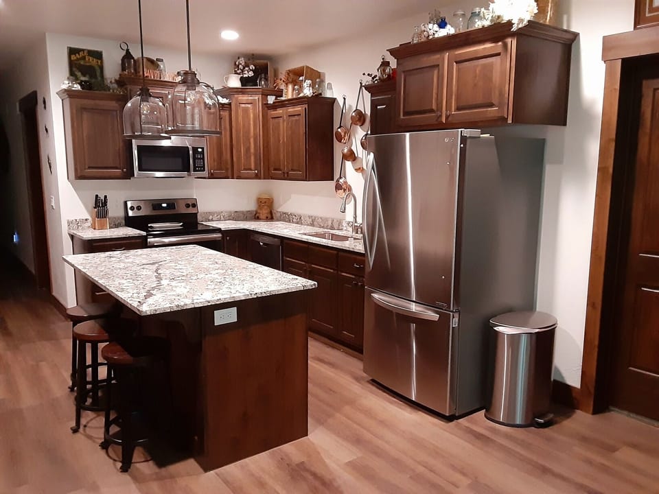 Large kitchen with dishwasher, stove, oven, microwave  and large refrigerator.