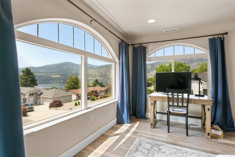 This bedroom offers a personal workspace with spectacular views.