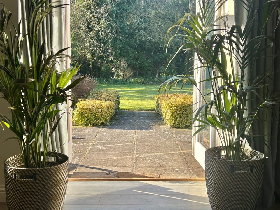 View from the reception room through the french windows to the charming garden
