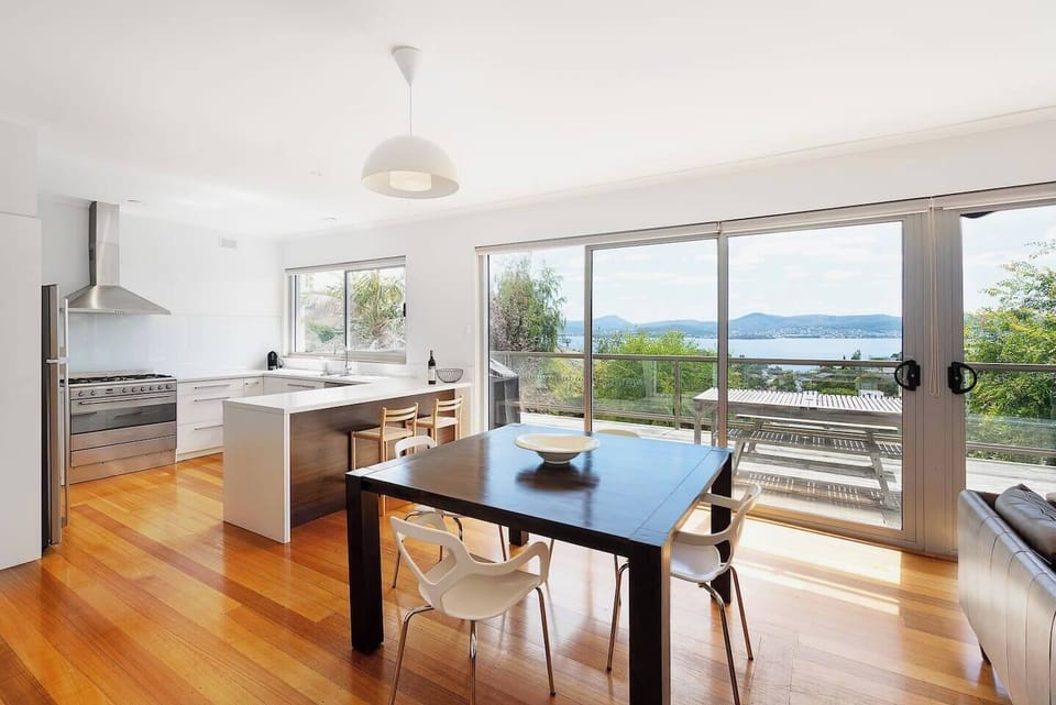 Savour intimate meals at the four-seater dining table, perfectly positioned to enjoy stunning river views.