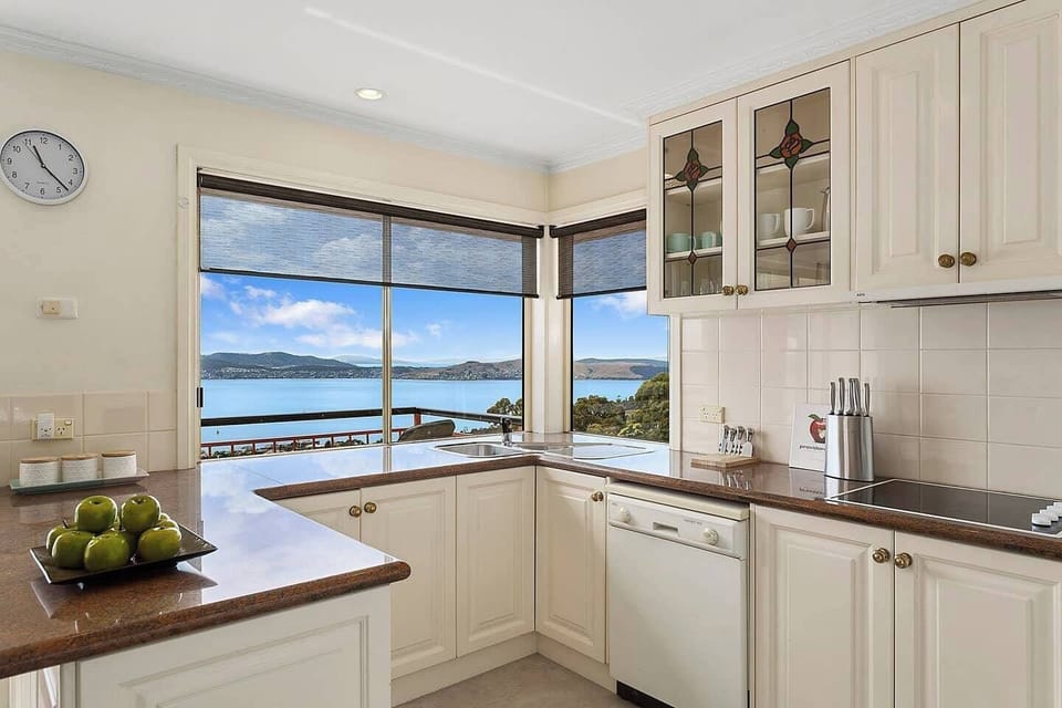 Enjoy beautiful water views from this stylish kitchen, where classic cabinetry and modern amenities make cooking a breeze.