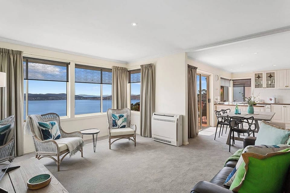 The living area seamlessly extends to the dining area and kitchen.