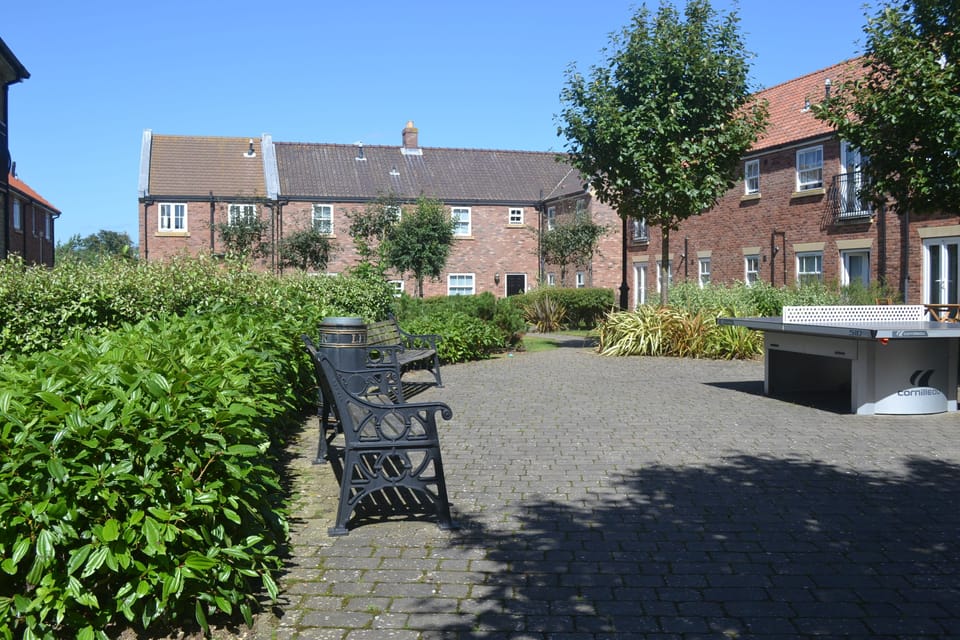 Seating area and outdoor table tennis with Filey Bay Haven located in the corner