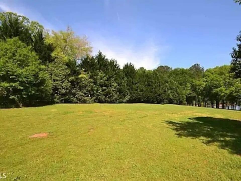Includes adjoining vacant lot, so lots of space and lined with trees for privacy