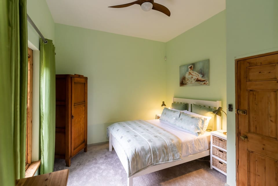 Downstairs bedroom with ceiling fan