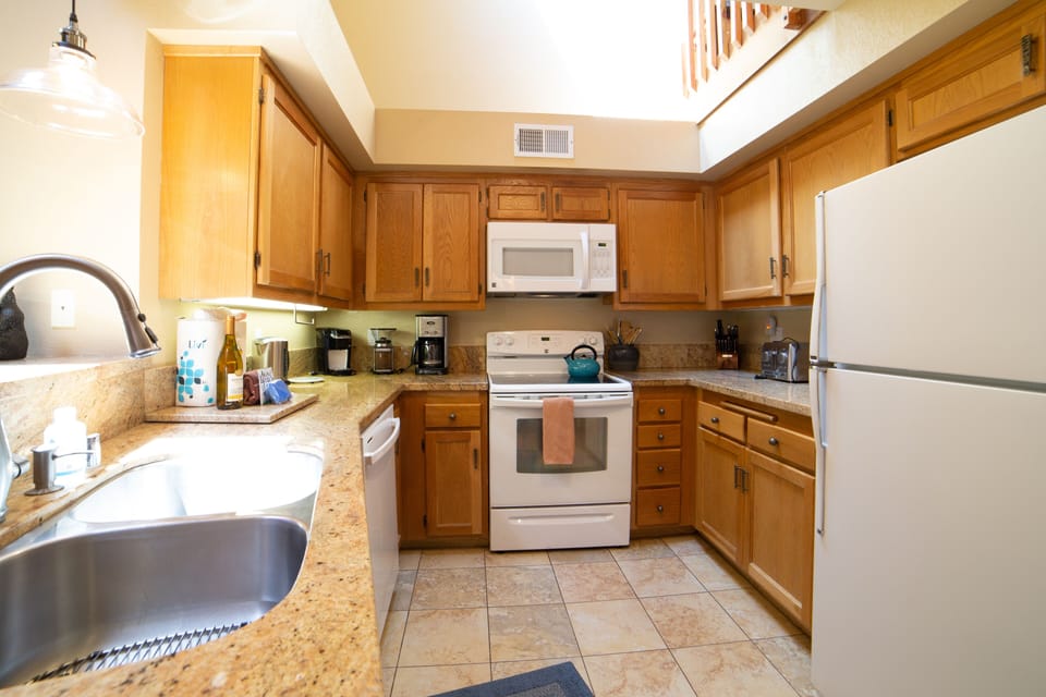Kitchen with Granite counters and updated appliances, vaulted ceilings and ample counter space