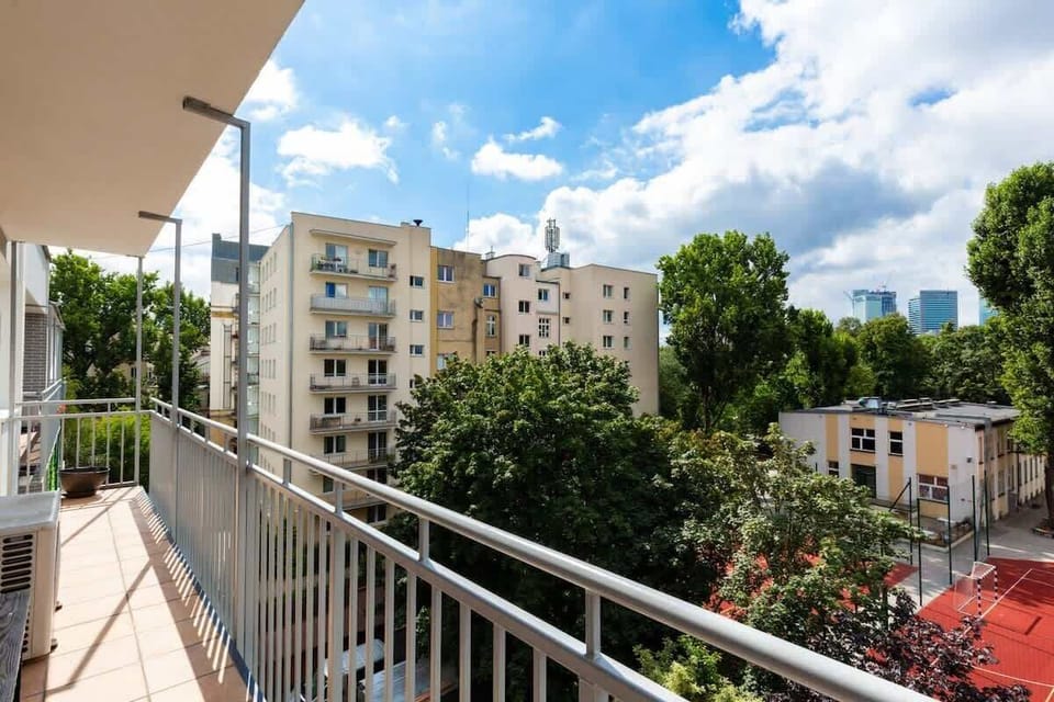 The balcony's stylish design complements the apartment's decor. 