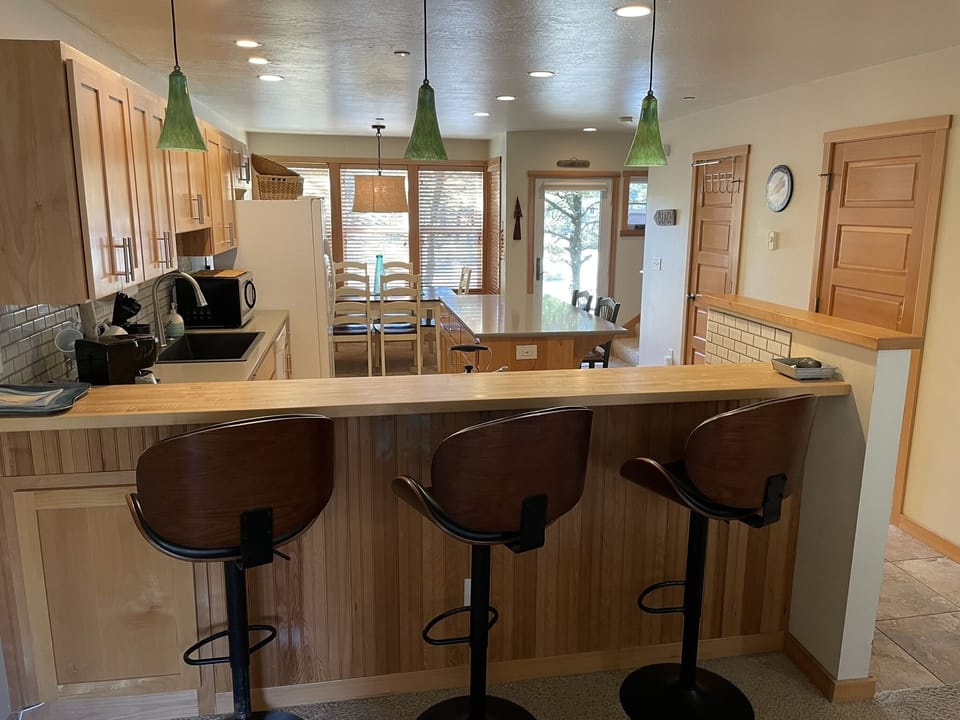 Breakfast bar and stools provide yet another space to sit and enjoy your time.