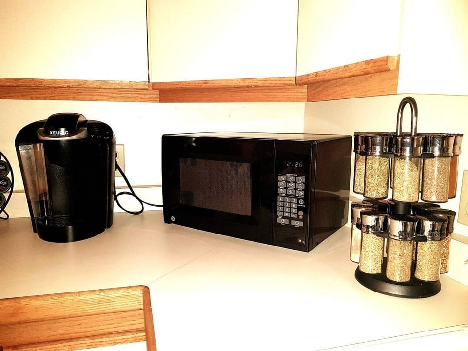 Keurig machine, microwave and cooking spices provided. 