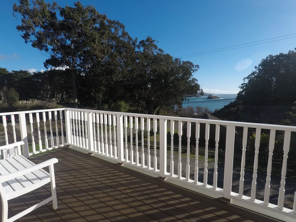 Enjoy the sunny upper deck and the waves below right outside the master bedroom.