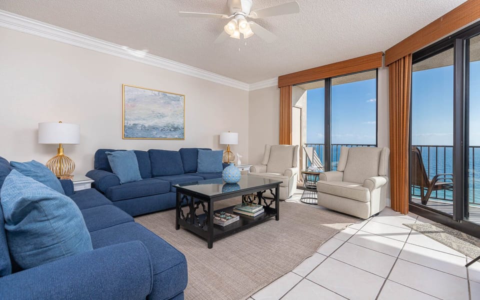 Relax in the spacious living area featuring a sofa with queen sleeper and stunning beachfront balcony views