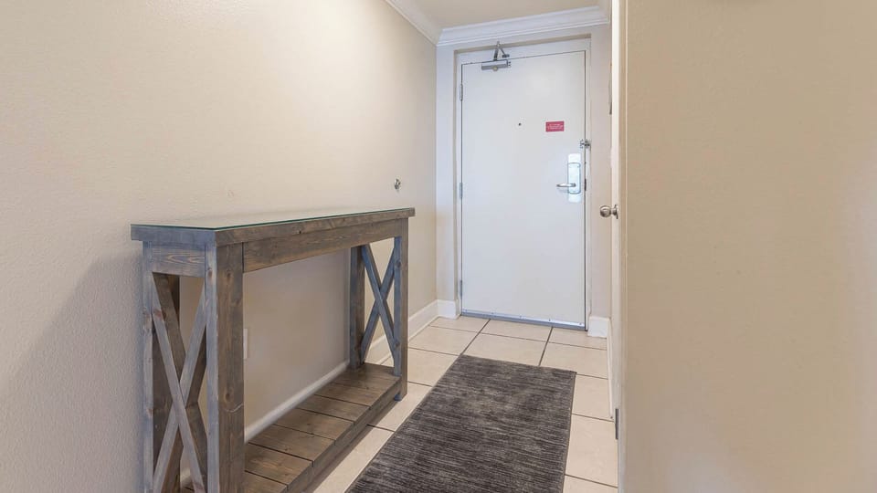 Welcoming entryway featuring a stylish console table and soft lighting, setting an inviting tone for your beach vacation