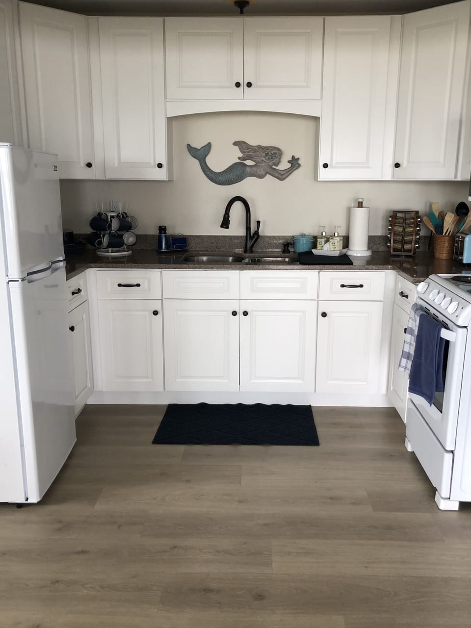Kitchen with microwave, electric stove and oven
