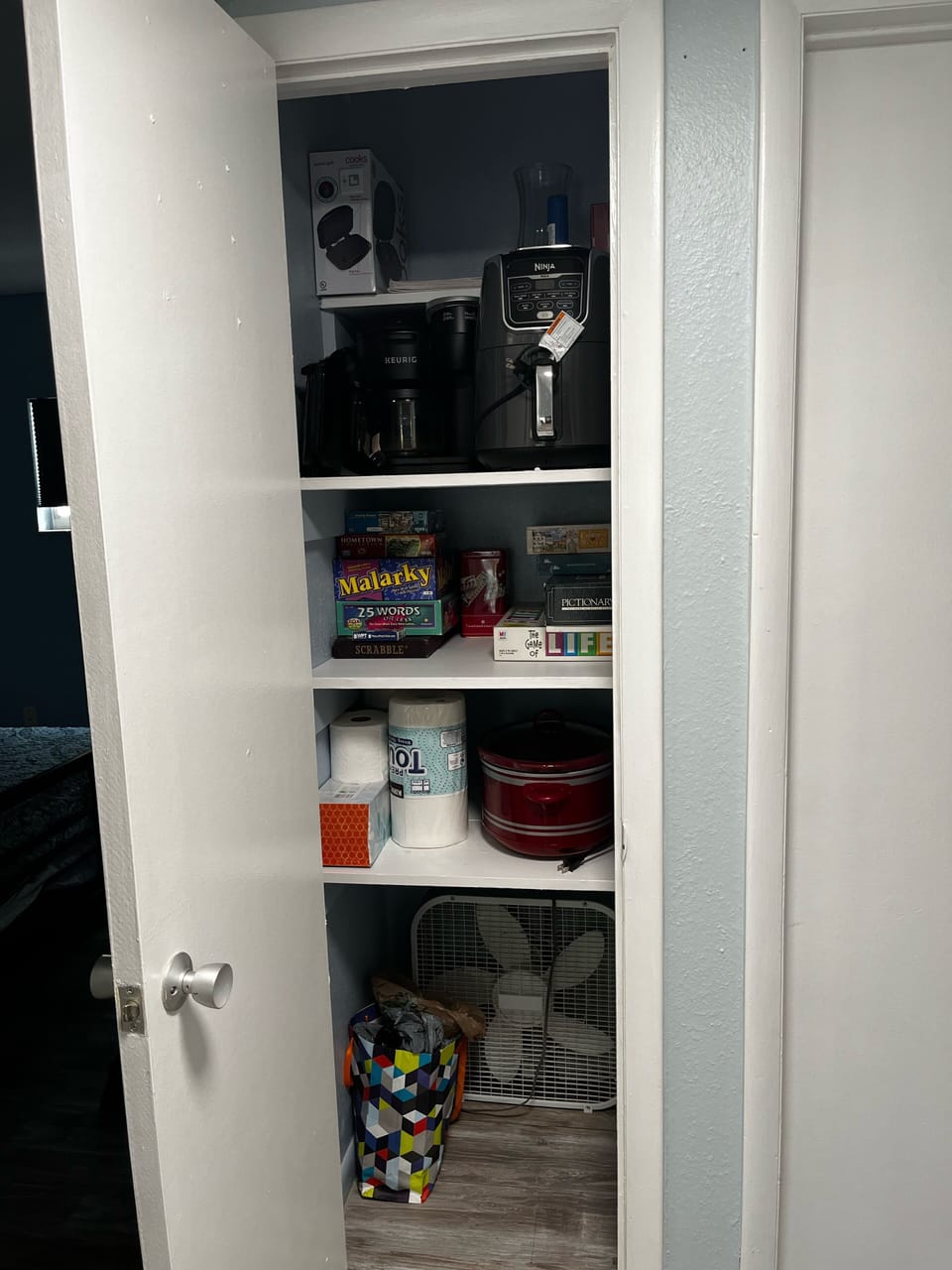 Hall closet-paper goods, games, puzzles, coffee pot, crockpot, airfryer 
