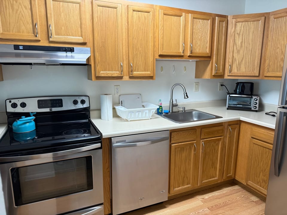 Step into a well-appointed kitchen designed for convenience. It includes a full-sized refrigerator, range, and plenty of counter space for meal prep. You'll find generous storage in the cabinetry, making it easy to keep things organized.