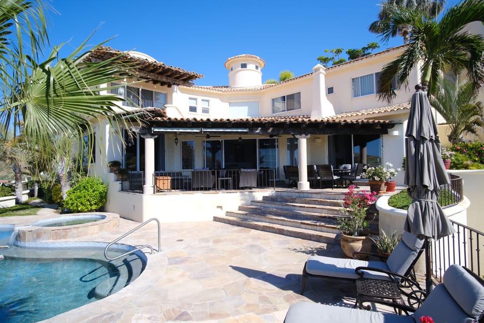The home from the back with enormous outdoor spaces.

