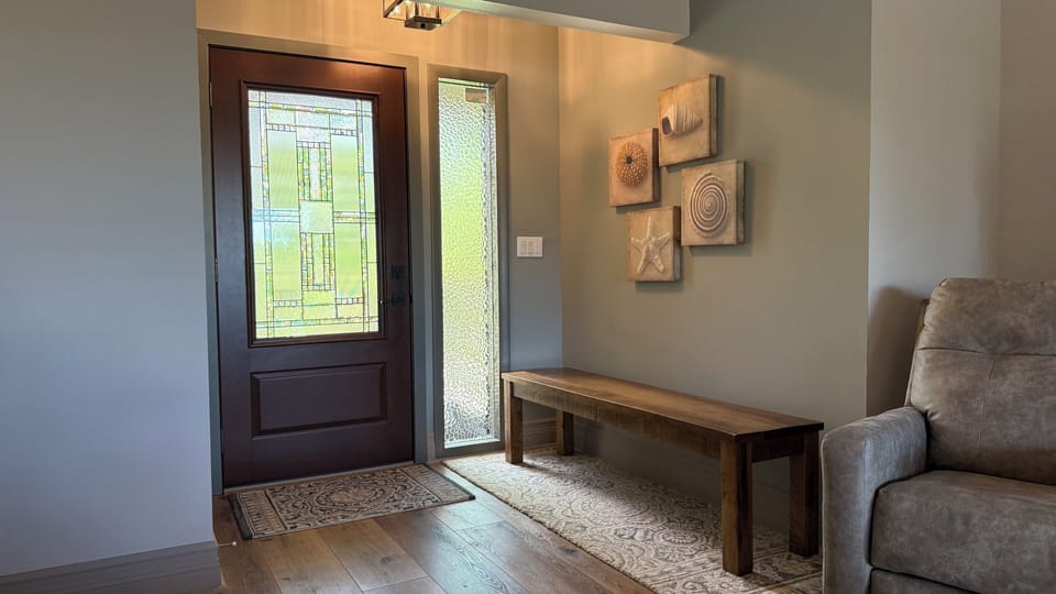 Front entry with bench, room for sandals/shoes under bench.