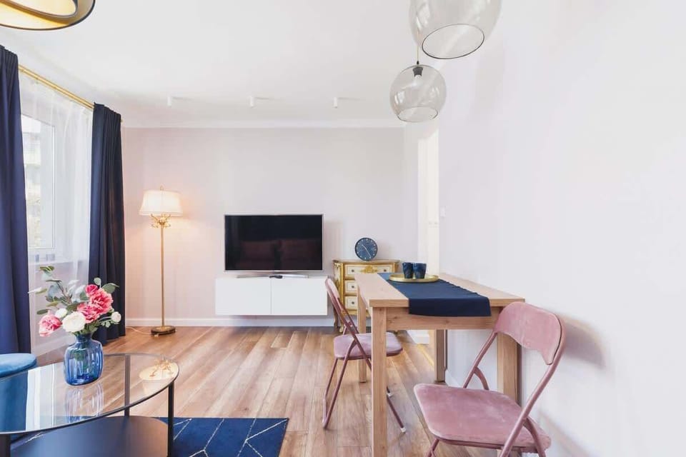 Living room with large windows flooding the room with natural light, highlighting its bright decor.