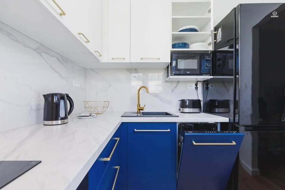 The kitchen featuring a sleek stove and a functional microwave. 