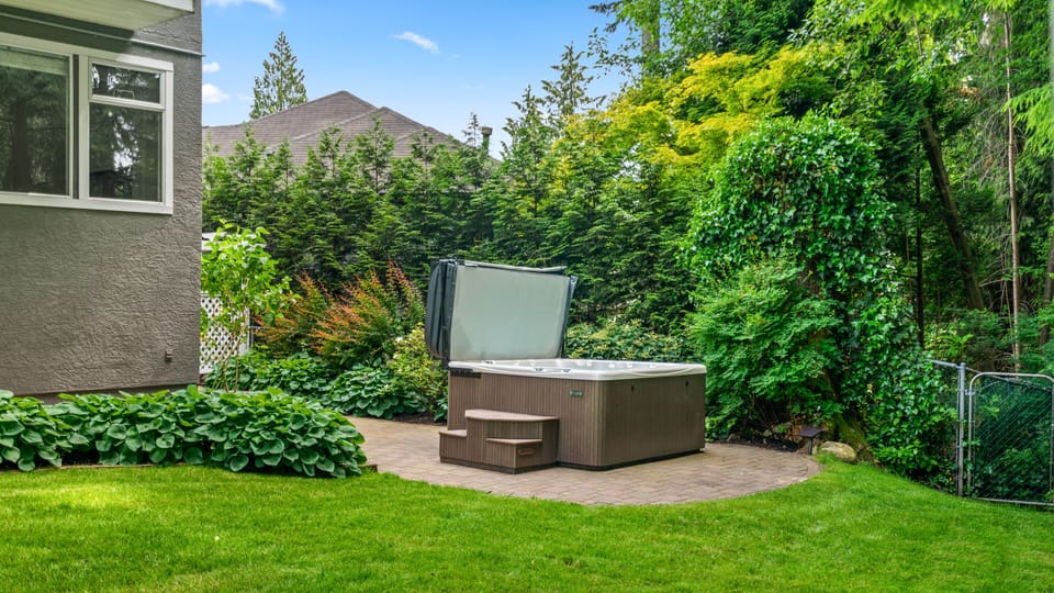 Exclusive access to a hot tub that is near a river and surrounded by a forest.