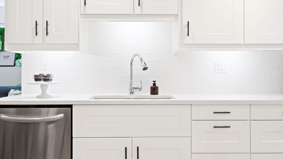 Kitchen: quartz countertops, dishwasher, stove, microwave, and refrigerator.