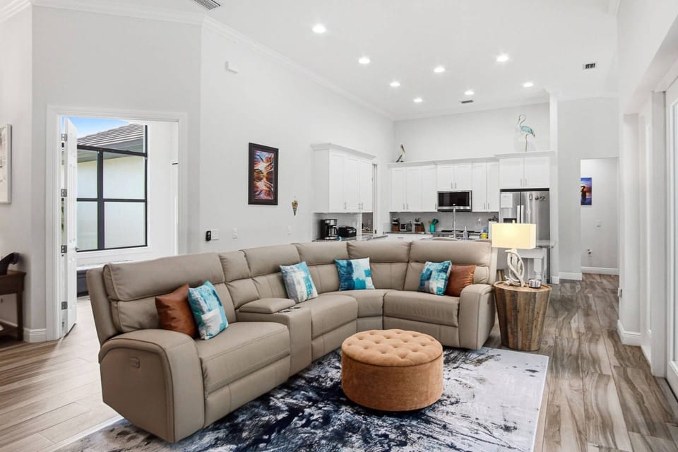 A living room with ample seating and an open concept.