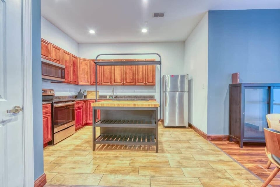 Enjoy home-cooked or the neighborhood's best takeout in this lovely kitchen with stainless steel appliances, a microwave, and a full-sized refrigerator.