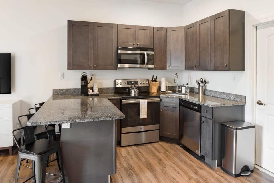 Enjoy home-cooked or the neighborhood's best takeout in this lovely kitchen with stainless steel appliances, a microwave, and a full-sized refrigerator