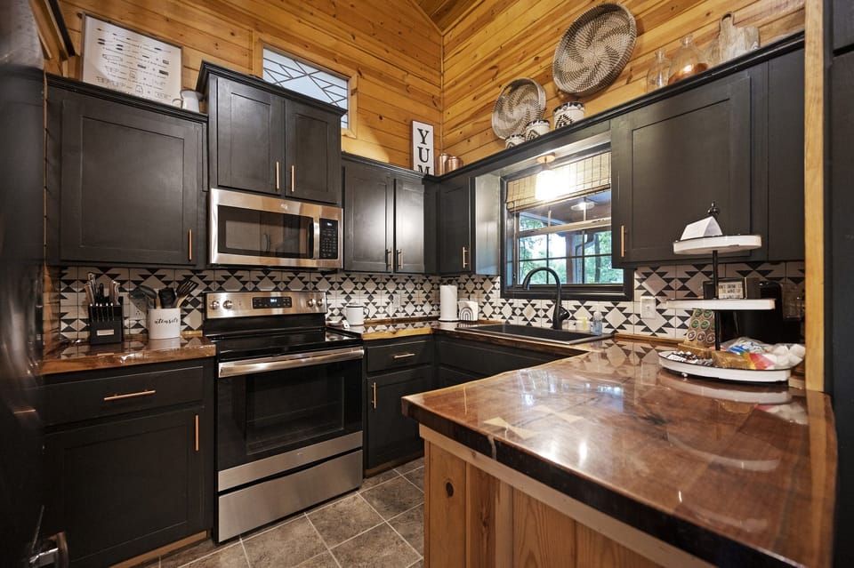 The kitchen is small, but fully stocked with full sized appliances!