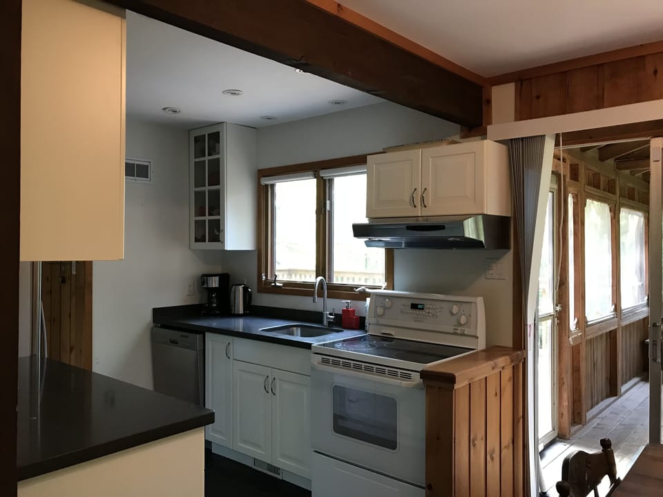 Direct access to the Muskoka Room and expansive back deck from the kitchen. 