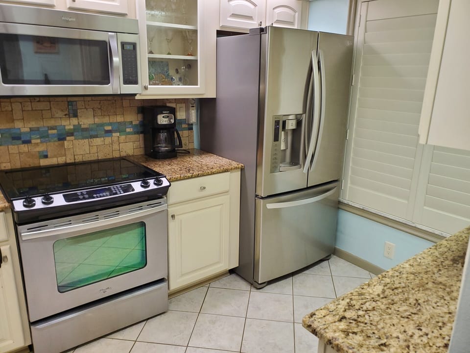 Fully stocked Kitchen with nice dishes and appliances 