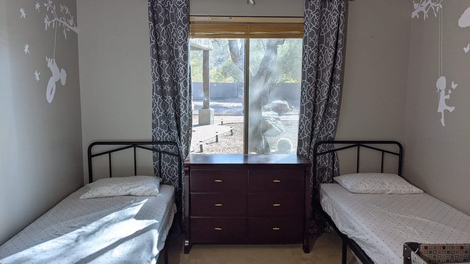 Bedroom with a mountain view and two twin beds.  Pack-n-Play provided too.