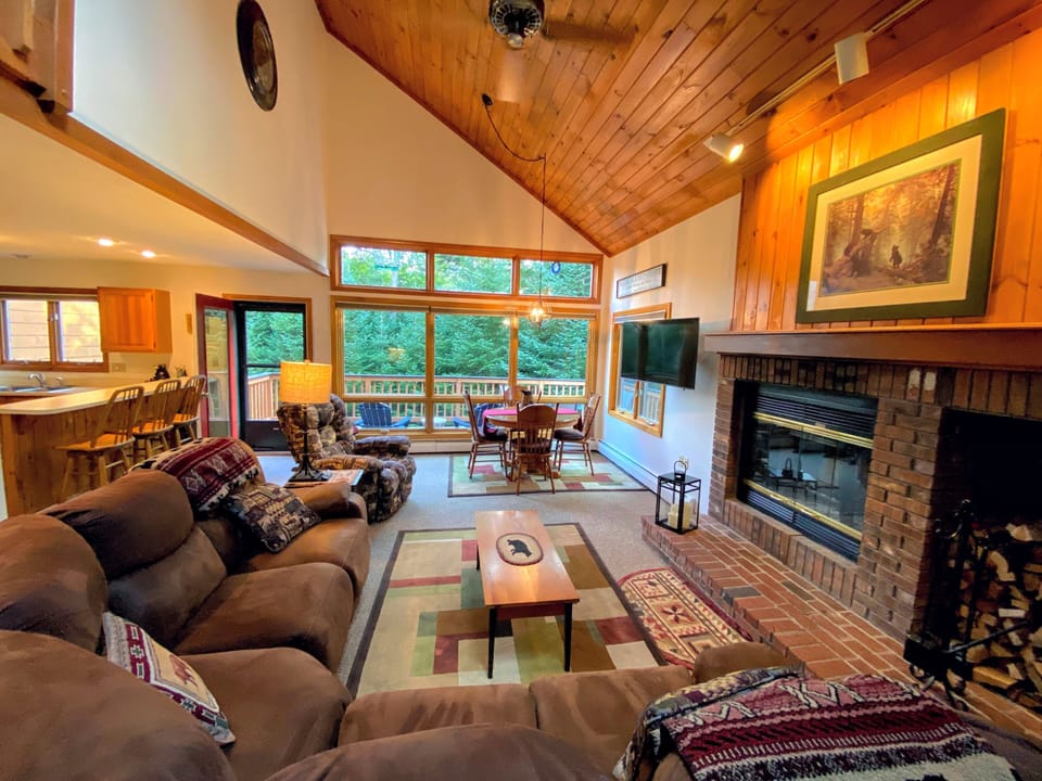The open-concept living room/dining room/kitchen has a wood-burning fireplace that adds ambiance on those cold nights