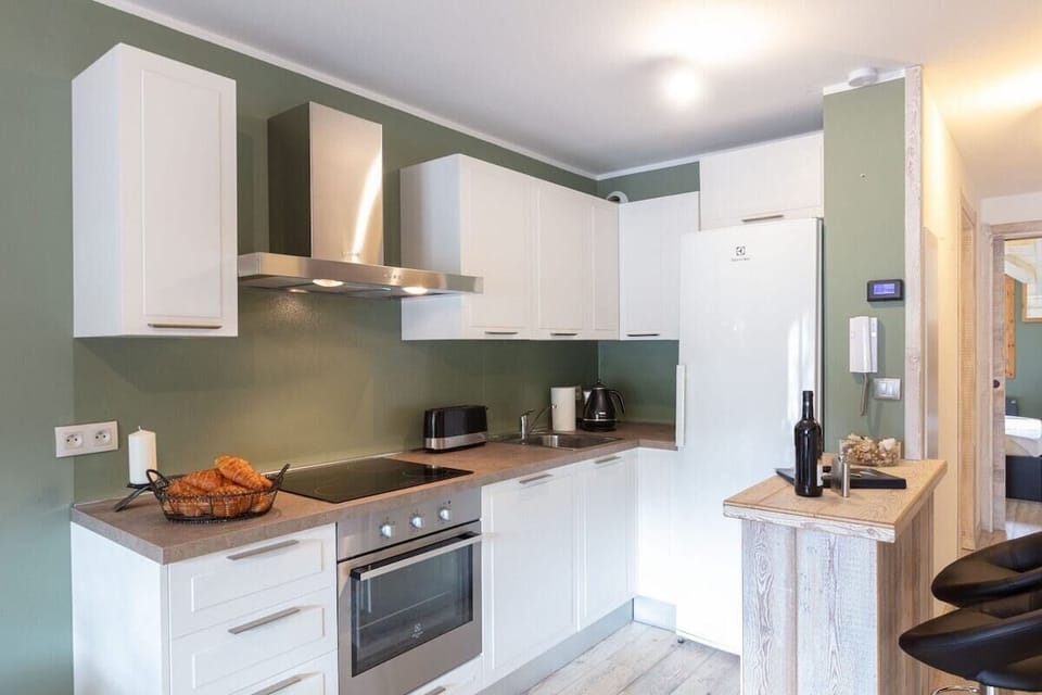 kitchen with fan oven, 4 ring hob, large fridge for ample food storage, freezer and breakfast bar for 2 persons