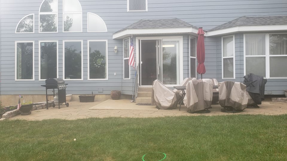 Patio with Chairs, Umbrella, Barbecue Grill to enjoy meals on the Patio