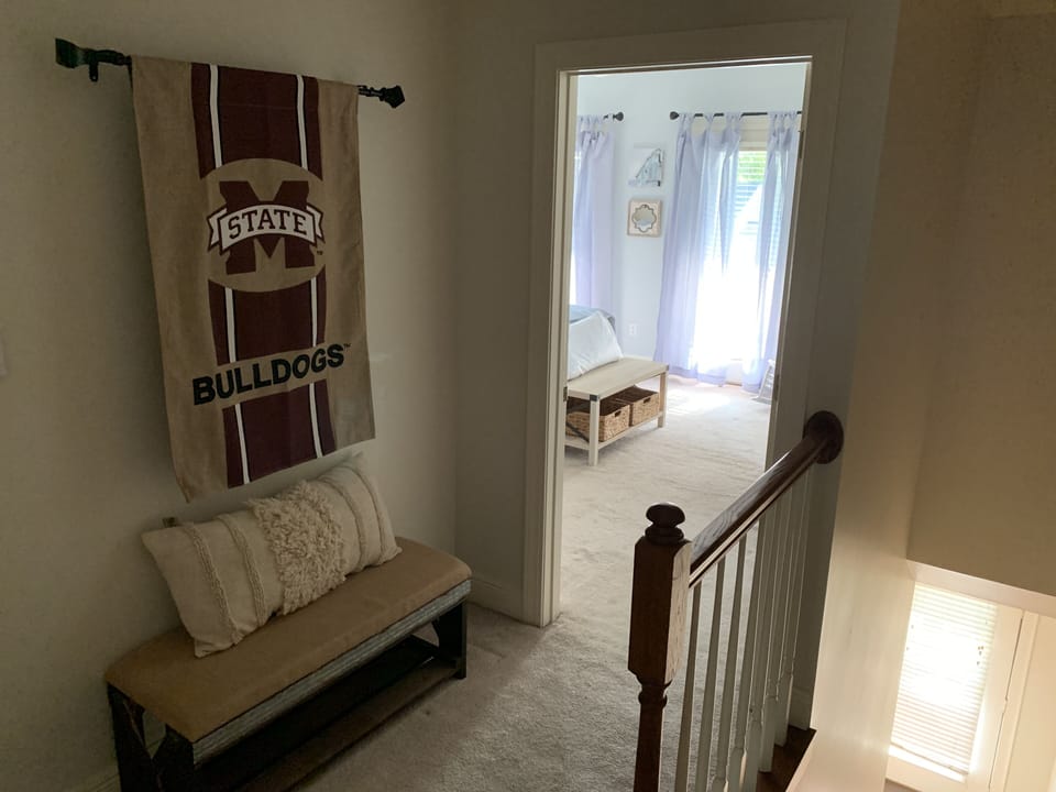 The upstairs hallway provides comfortable seating for two.