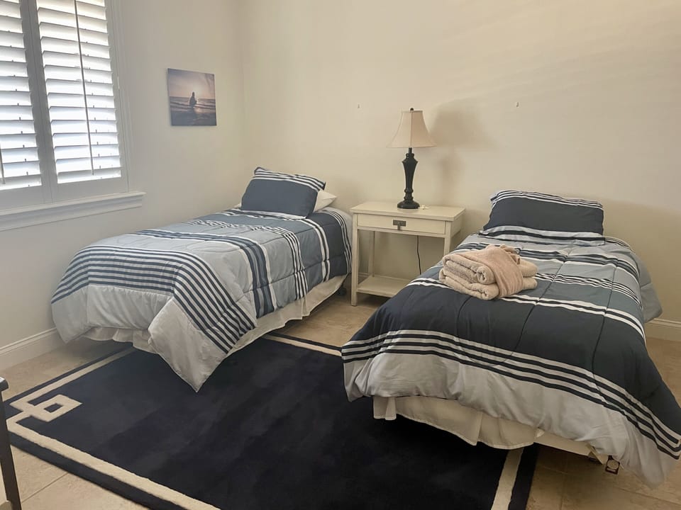 Two twin beds with full bathroom shared with living area